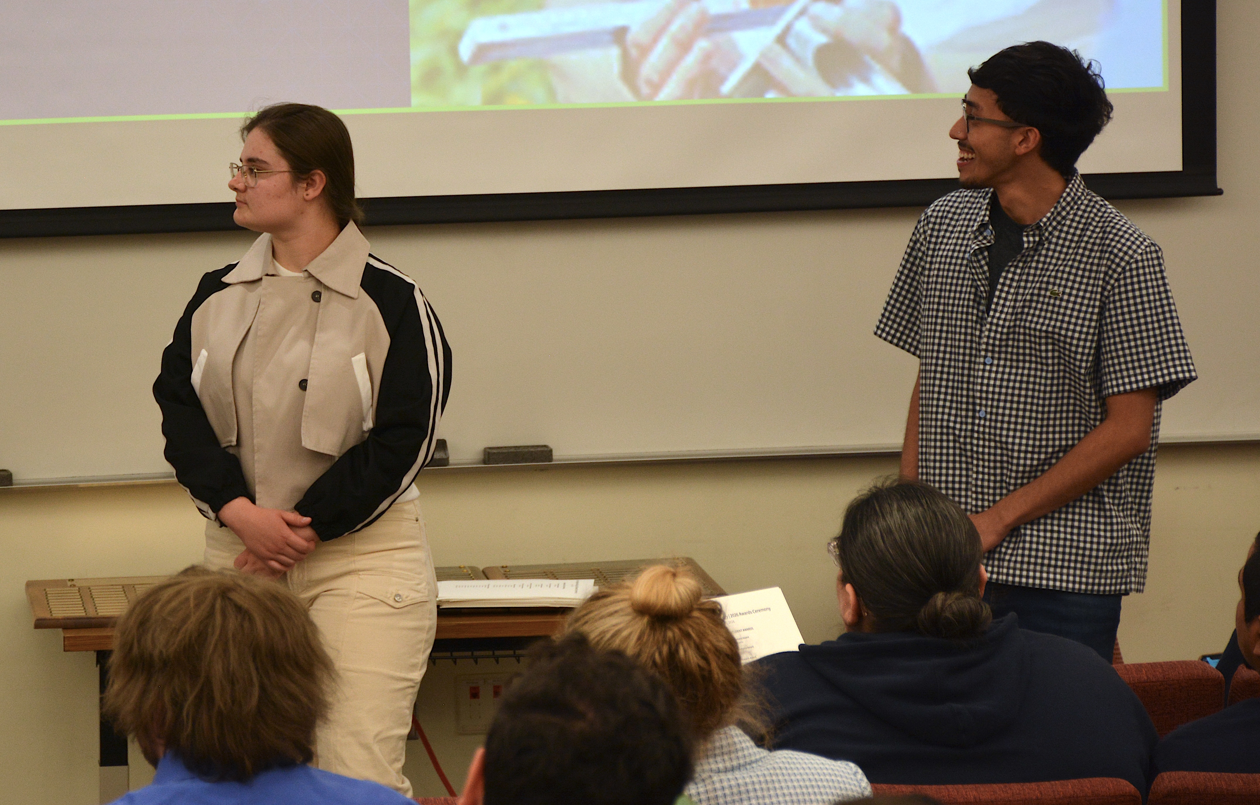 A student smiling and another looking off to the left