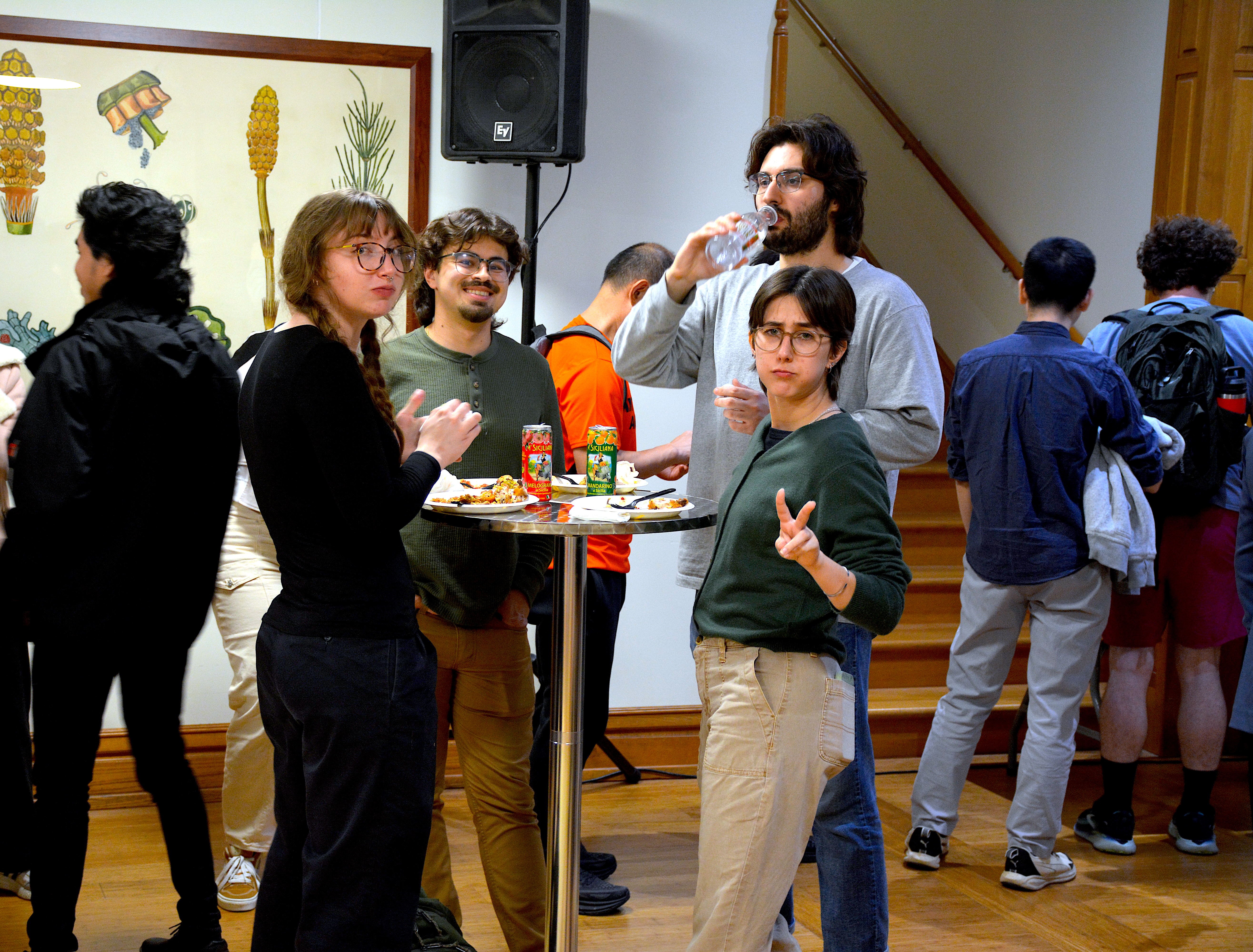 A group of 4 people smiling and posing at a table
