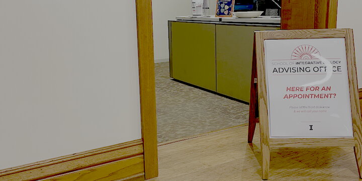 a photo of a doorway with a sign for SIB advising in front of it