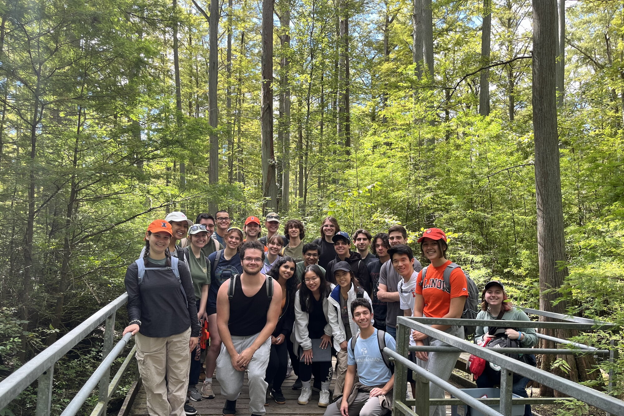 a group of students standing on a bridge