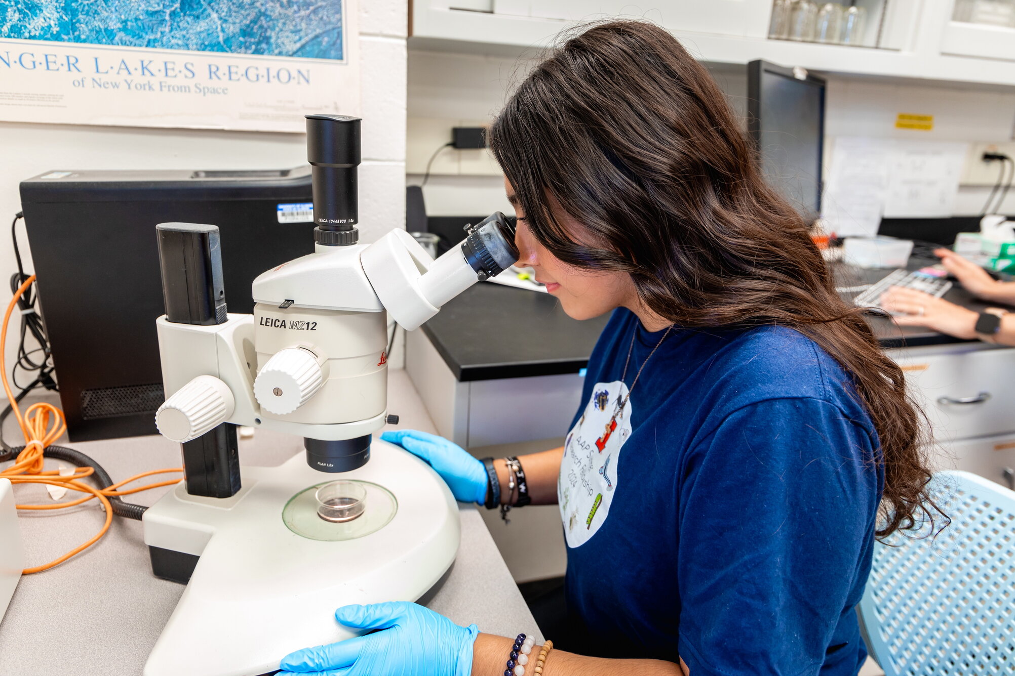 A student looking through a magnifying glass