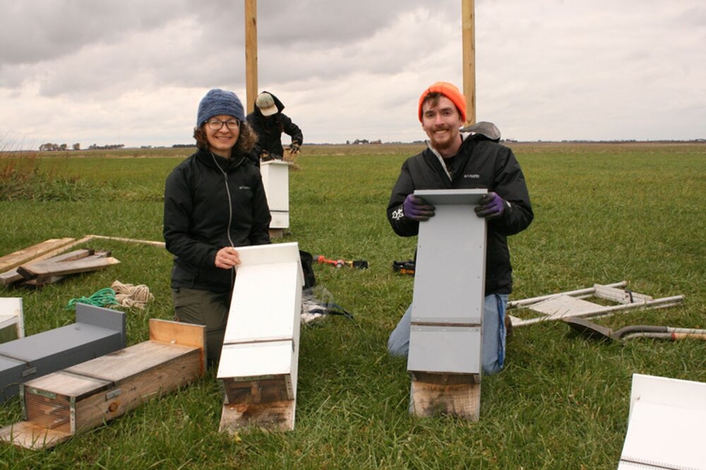 Joy O'Keefe (left) and Reed Crawford (right) with bat boxes installed for a previous study.