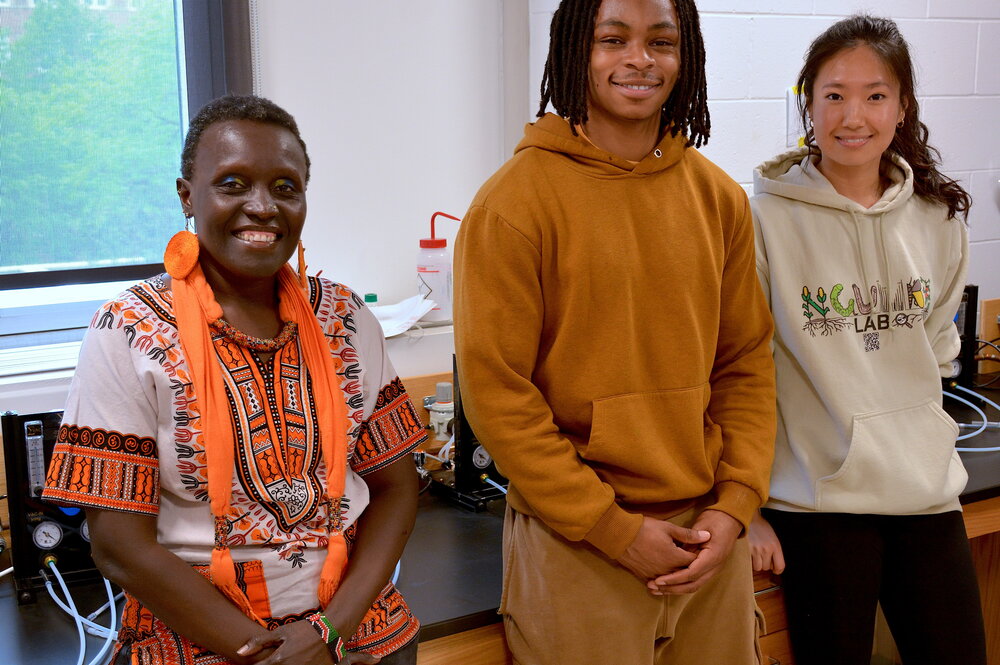 Three people smiling for a photo