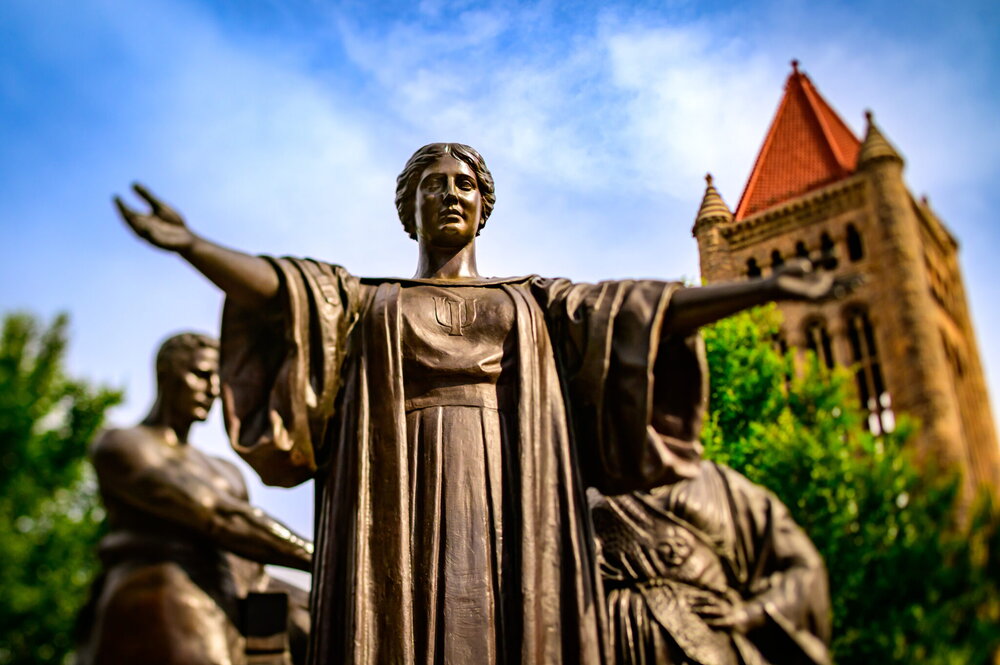 A statue with a blue sky in the backgrounds