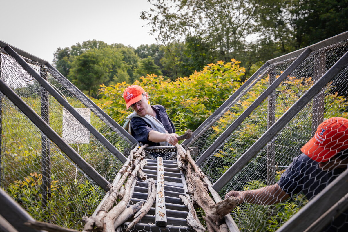 A photo of a student working with a trap outdoors