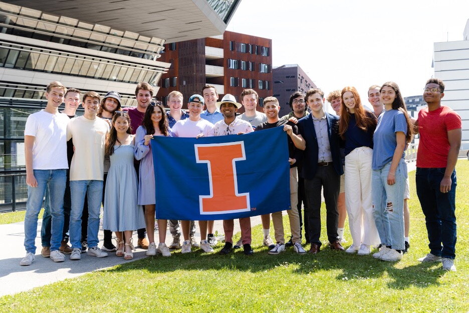 Illinois students in Vienna holding block-I flag