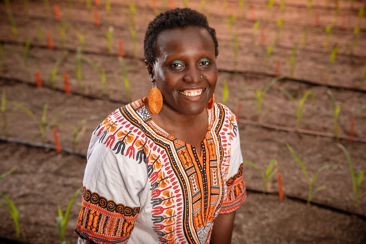 Esther Ngumbi standing in a field