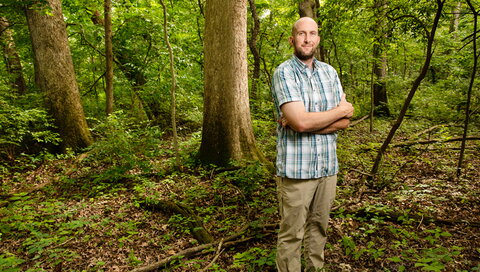 man smiling in woods