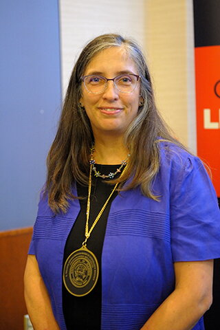 photo of smiling woman with medal