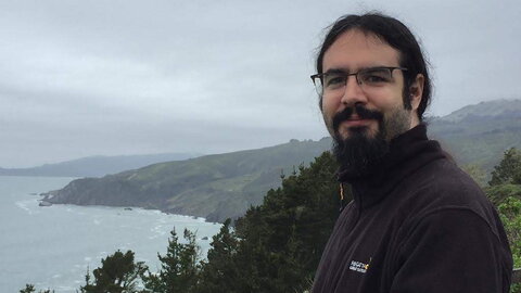 smiling man at a coastline