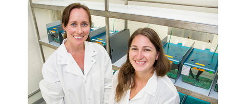 two smiling women in lab coats