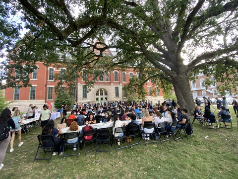 students sitting on the north lawn of the Natural History Building