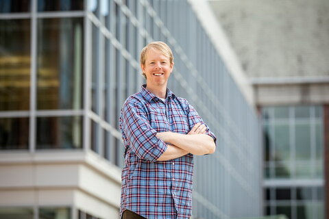 Plant biology professor James O'Dwyer standing outside the IGB on campus. 