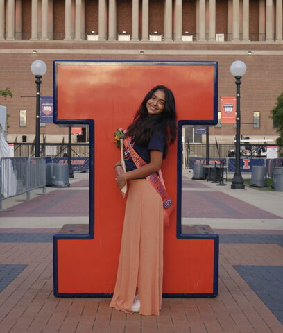 A woman standing in front of the block I