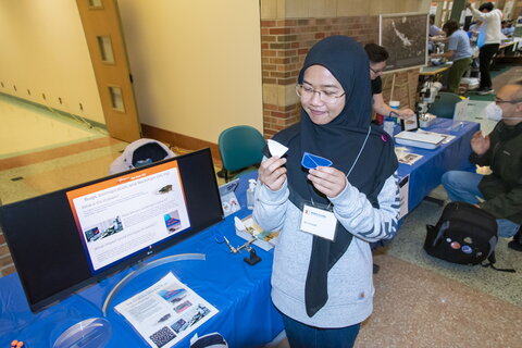 Siti providing a presentation in front a screen