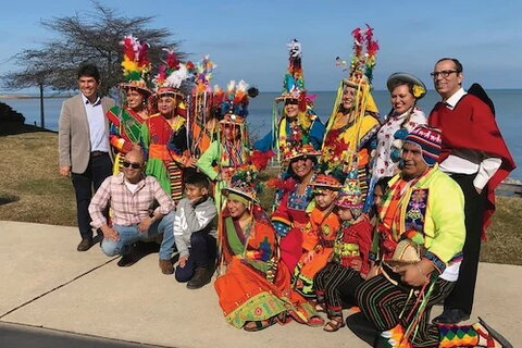 A group of people dressed in traditional Quechua heritage garb by Lake Michigan in Chicago