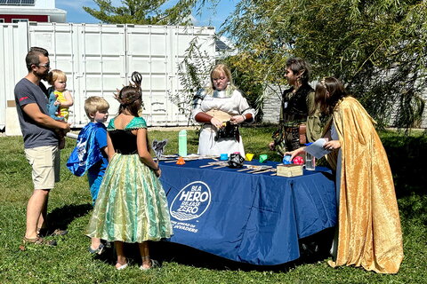 A group of people in cosplay around a table