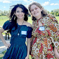 Two women dressed as elves smiling