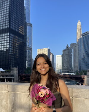 Esha standing in front of sky scrapers
