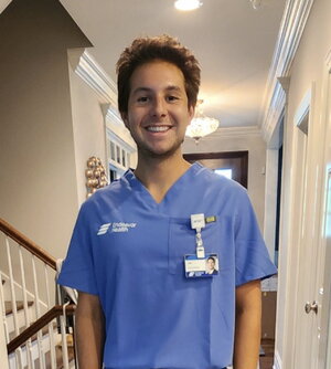 Luc wearing scrubs