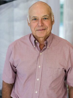 a man in a pink button up shirt with a white background