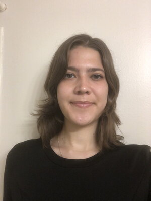 A woman with long hair in a black shirt