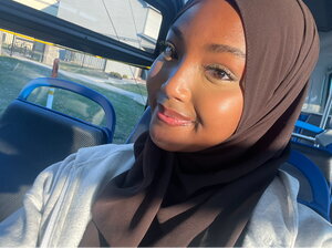 A smiling woman in a car