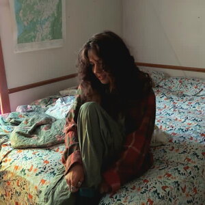 a woman with her head down on a bed