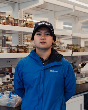 A man in a hat and blue jacket in a store