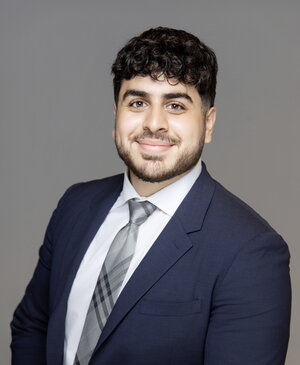 A smiling man in a suit