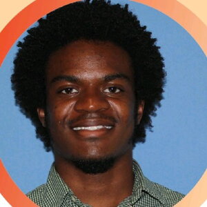 A man smiling with a colorful circular border around his headshot