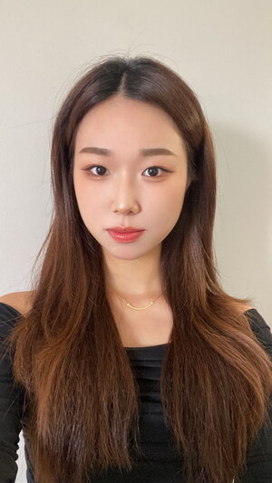 A brunette woman wearing a black shirt