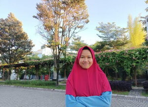 A smiling person outside