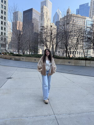 Girl standing in front of city buildings 