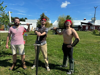 Joe Spina (right) with two other volunteers at their station showing how to defeat invasive species.