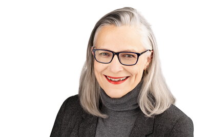 A woamn in glasses smiling