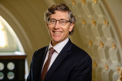 A smiling man in a suit