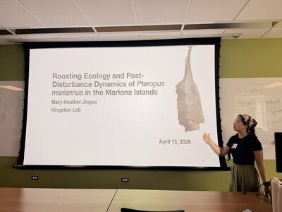 a woman presenting a powerpoint on a projector screen