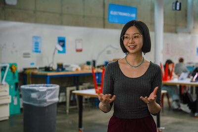 A woman with her hands open in an art center