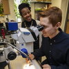 man looking into a microscope