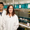 two smiling people in lab coats