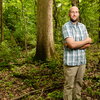 man smiling in woods