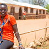 smiling woman sitting on a fence