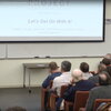 man in suit speaking at a lecture