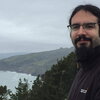 smiling man at a coastline