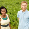 two smiling people at a field