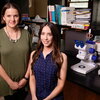 two smiling women in a lab