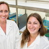 two smiling women in lab coats