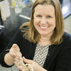 woman holding a small animal skeleton