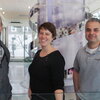 three smiling people